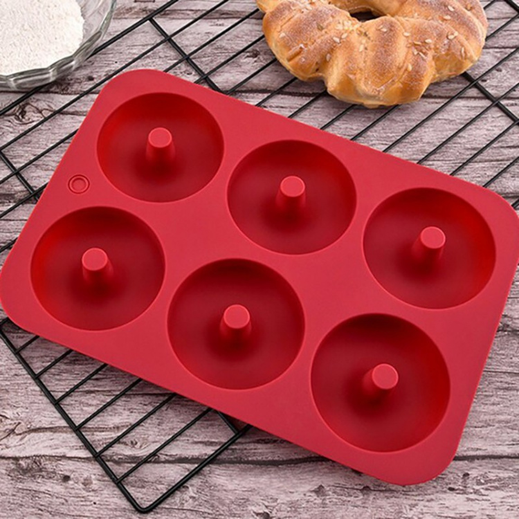Donut-shaped silicone mold, red.