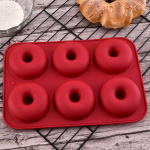Donut-shaped silicone mold, red.